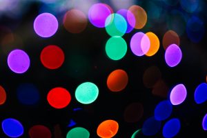 Coloured lights and black background photo by dominik vanyi on Unsplash